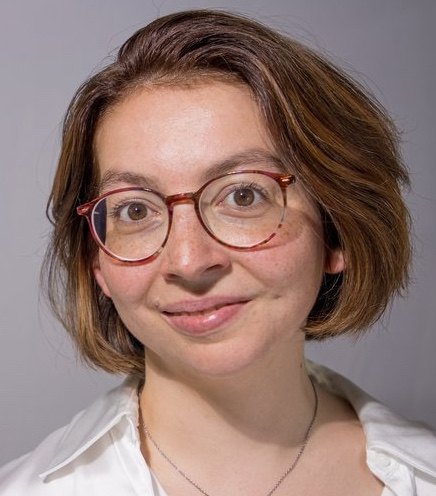 a short haired woman with glasses